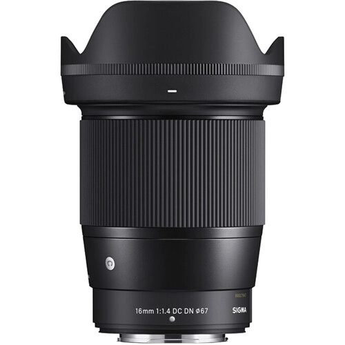 Combining a comfortable wide-angle design with an ultra-fast maximum aperture, the 16mm f/1.4 DC DN is part of Sigma's Contemporary series of lenses and designed for use with Nikon Z-mount mirrorless cameras. Characterized by its bright f/1.4 maximum aperture, this lens is adept at working in low-light conditions and also affords increased control over depth of field for selective focus control. The optical design makes use of several low dispersion and aspherical elements, which control color fringing and various aberrations in order to provide high sharpness and clarity throughout the aperture range. Individual elements also feature a super multilayered coating to suppress flare and ghosting for greater contrast and color fidelity when working in strong lighting conditions. Benefitting the optical assets, this lens also sports a stepping AF motor for quick, quiet, and smooth focusing performance that suits both still photography as well as video applications. As part of the Contemporary line within Sigma's Global Vision series, this lens is designed to achieve a balance between convenience and performance, and meshes a compact, lightweight build and versatile handling with notable optical attributes. Wide-angle prime is designed for APS-C-format Nikon Z-mount mirrorless cameras and provides a 24mm equivalent focal length. Bright f/1.4 maximum aperture excels in low-light conditions and also affords increased control over depth of field for achieving selective focus effects. Two special low dispersion (SLD) elements and three F low dispersion (FLD) elements reduce color fringing and chromatic aberrations in order to achieve greater clarity and color accuracy. Two aspherical elements are used to limit distortion and spherical aberrations and also contribute to greater overall sharpness and accurate rendering. A super multilayered coating has been applied to lens elements in order to minimize lens flare and ghosting and contribute to producing contrast-rich and color-neutral imagery, even in backlit conditions. A stepping AF motor benefits both photographers and videographers with its fast, precise, and near-silent performance. Rounded nine-blade diaphragm contributes to a smooth and pleasing bokeh quality. The bayonet mount is constructed from brass to ensure accuracy and durability. Additionally, rubber sealing in the mount design renders it dust and splash resistant.